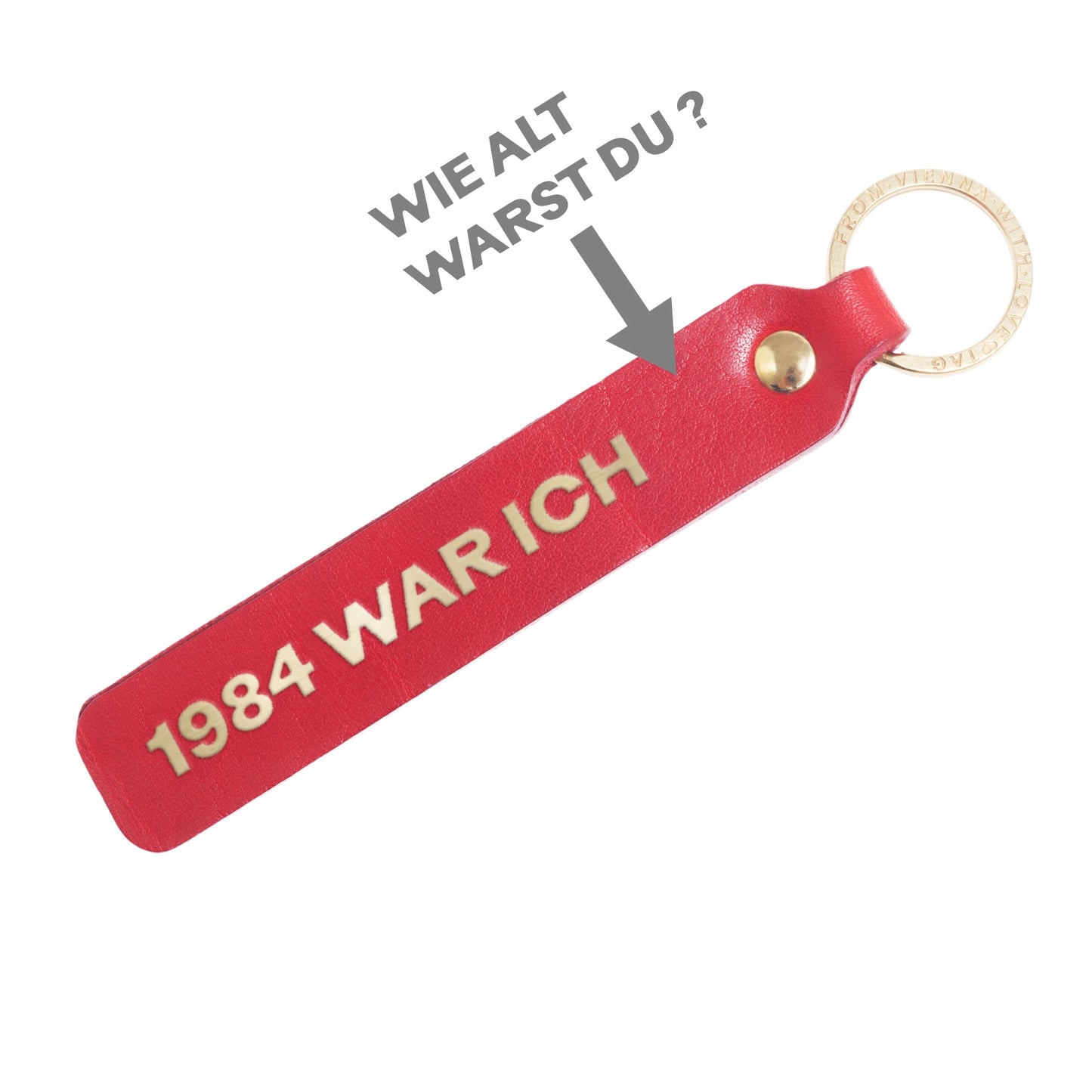 Flatlay, Schlüsselanhänger aus Leder in Rot mit Goldprägung '1984 war ich X' von LoveTag, handgefertigt in Wien