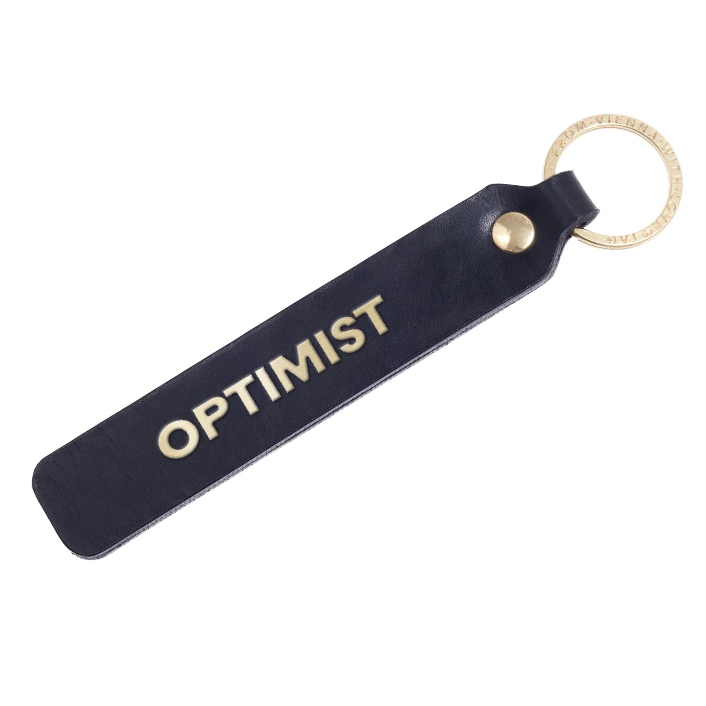 Flatlay, Schlüsselanhänger aus Leder in Schwarz mit Goldprägung 'Optimist' von LoveTag, handgefertigt in Wien