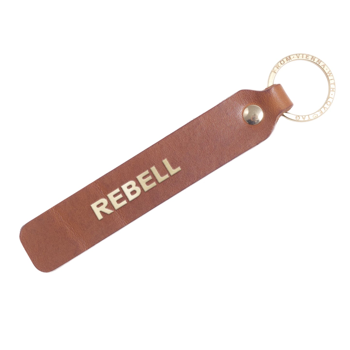 Flatlay, Schlüsselanhänger aus Leder in Natur mit Goldprägung 'Rebell' von LoveTag, handgefertigt in Wien